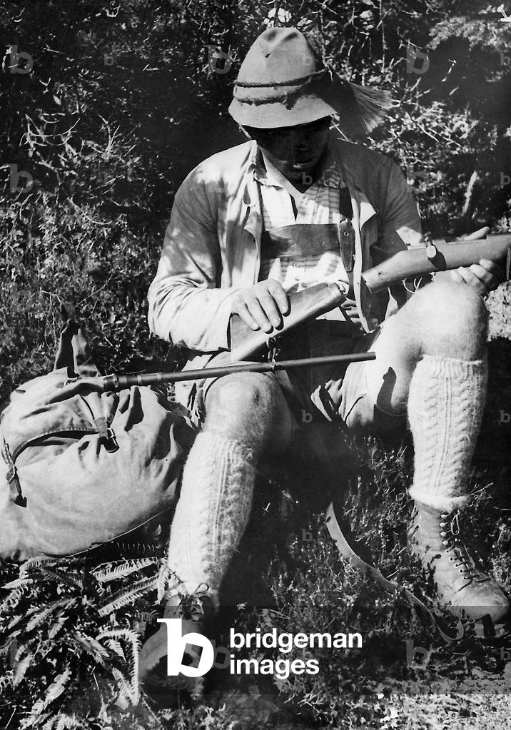 Poacher with carbine (b/w photo)