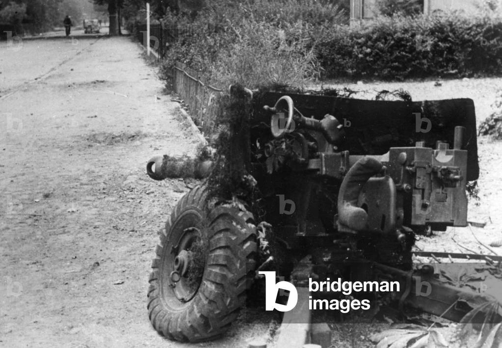 Destroyed British antitank gun on a street in Holland, 1944 (b/w photo)