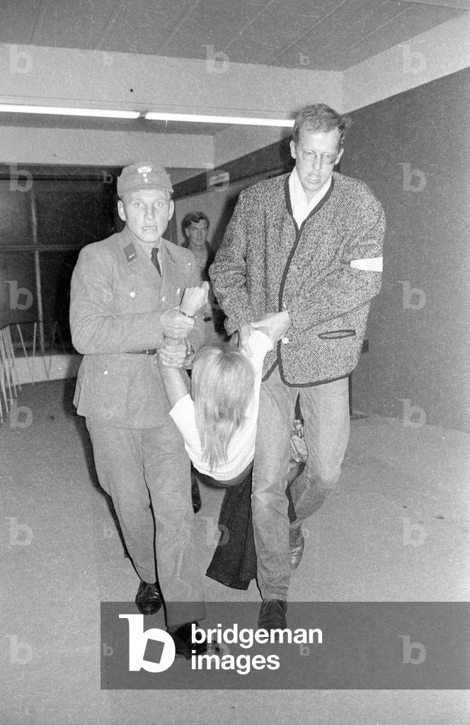 Member of the APO is being carried away from the Bayernhalle in Munich, 1969 (b/w photo)