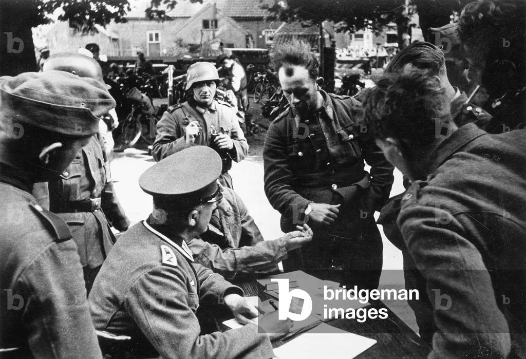 German soldiers register Dutch prisoners, 1940 (b/w photo)