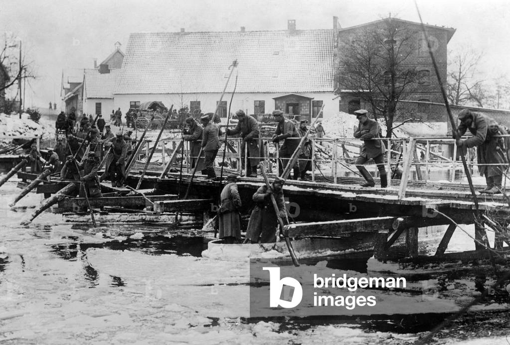 German soldiers break ice at a temporary bridge in East Prussia, 1914  (b/w photo)