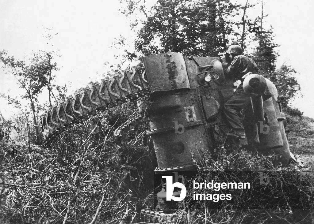 German soldier by a destroyed Sherman, 1944 (b/w photo)