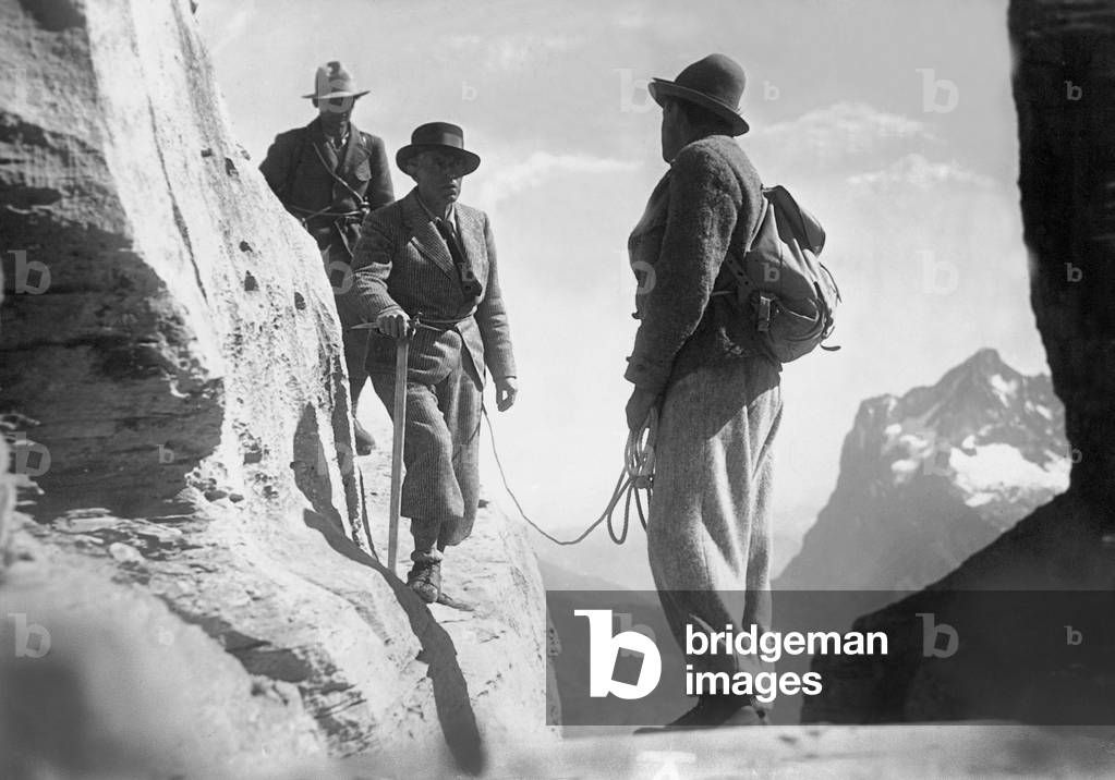 Mountaineers on a rock face (b/w photo)