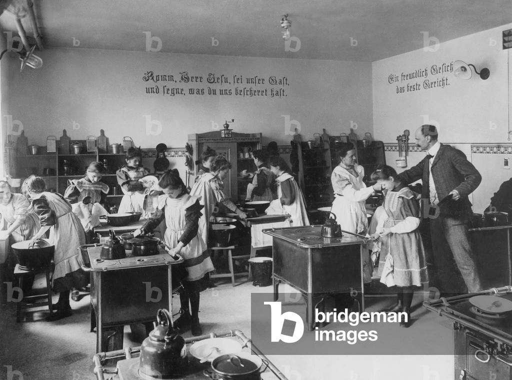 Schoolgirls learning home economics, 1908 (b/w photo)