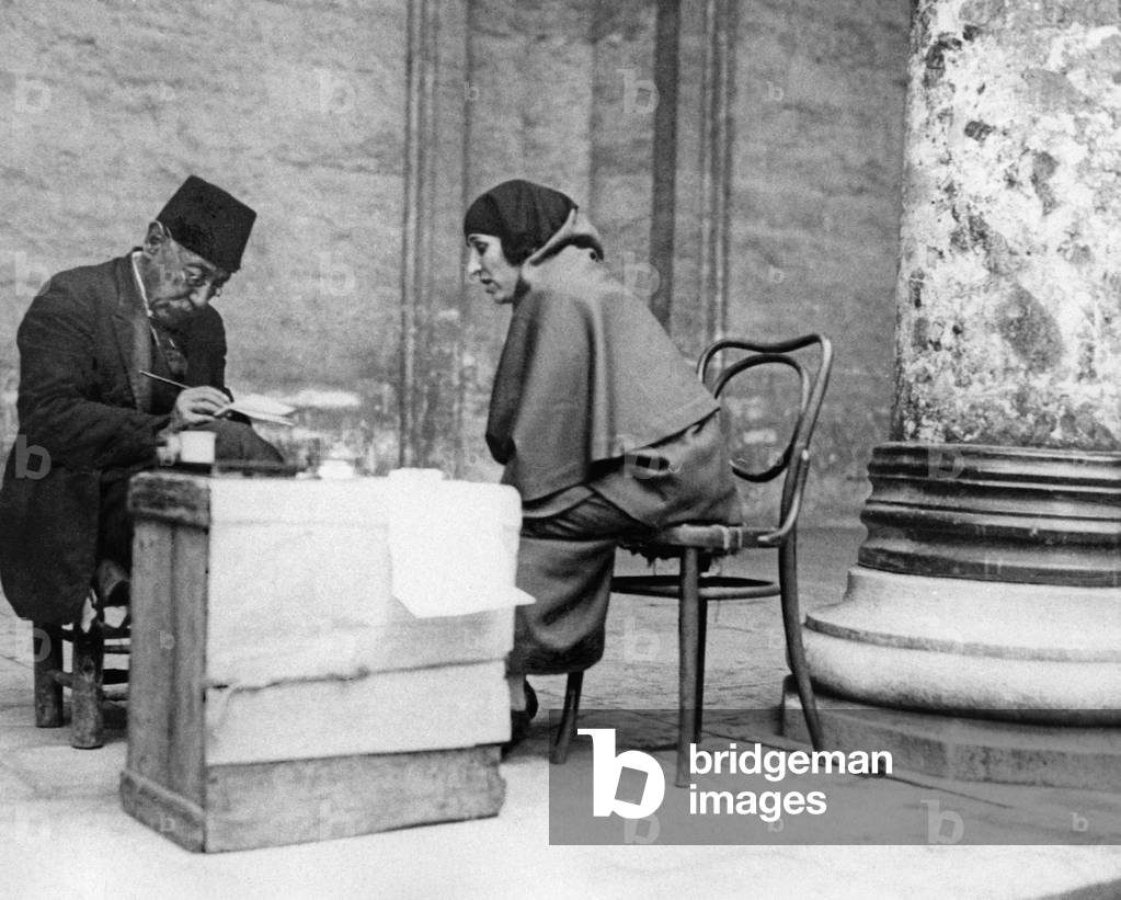 An illiterate woman dictates a letter, 1925 (b/w photo)