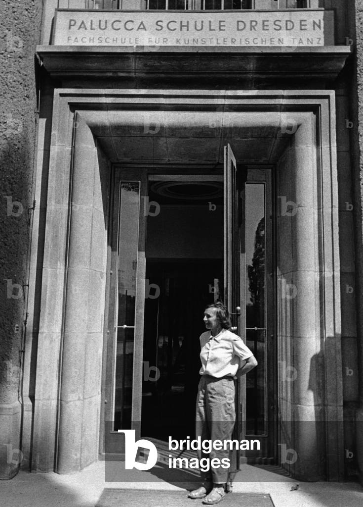 Gret Palucca in front of the entrance to her dance school in Dresden, 1956 (b/w photo)