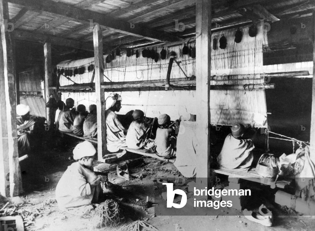 Child labour in a carpet weaving mill in India (b/w photo)