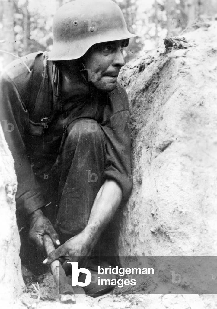 German soldier in a trench on the Eastern front (b/w photo)