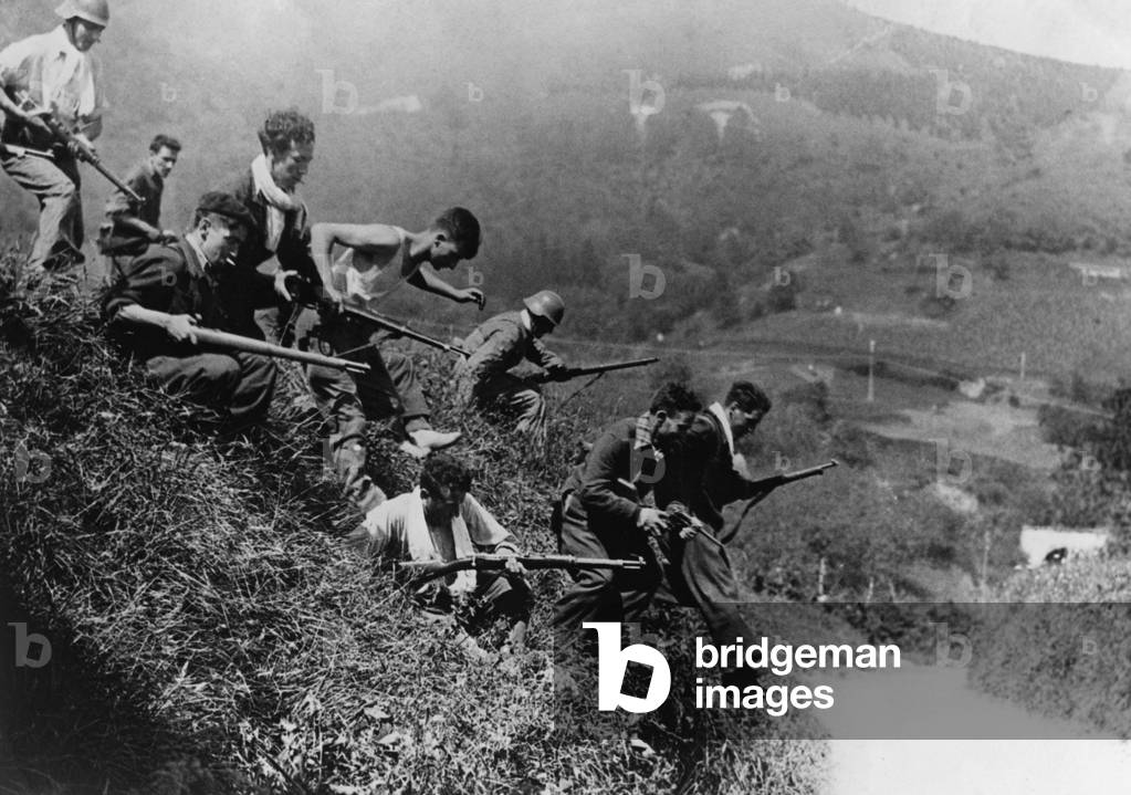 Republican fighters storm down an embankment at Irun, 1936