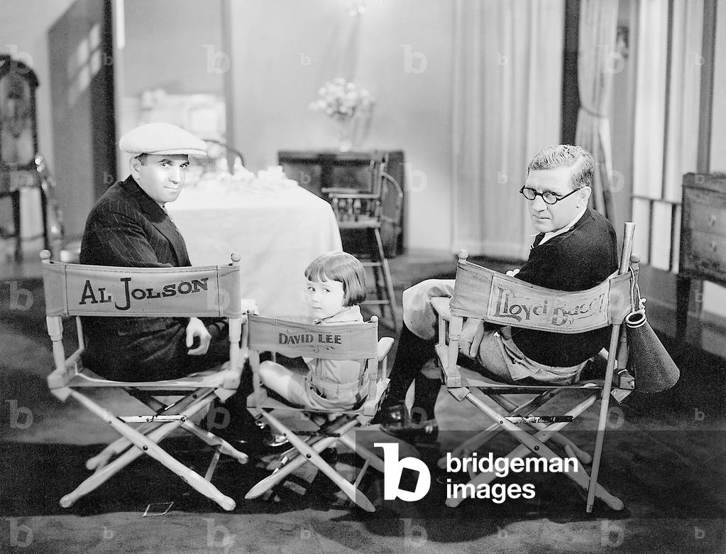 Al Jolson, Davey Lee and Lloyd Bacon during a break in filming for 'Say it with songs', 1929 (b/w photo)