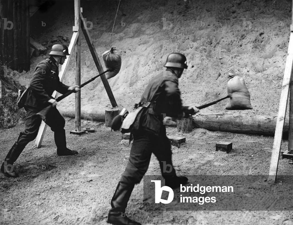 Bayonet training on sandbag, 1938 (b/w photo)