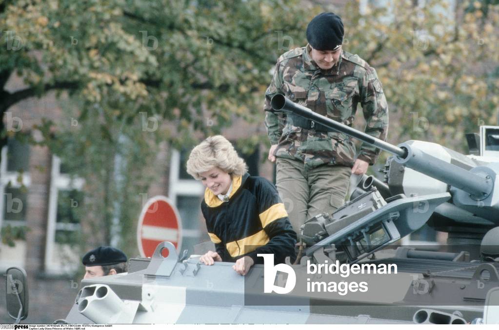 Lady Diana Princess of Wales 10/85 rud wife Princess England UK nobility wife of Prince Charles of Wales blond casual jacket armored soldier outside call half crosswise