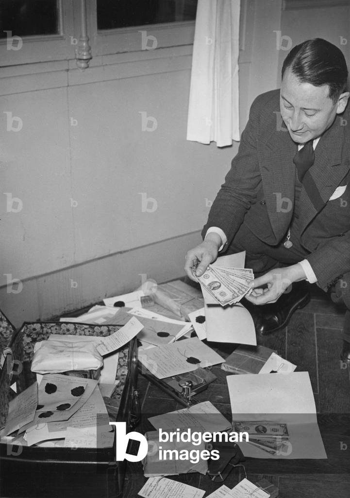 Confiscated counterfeit money in Brunoy, 1939 (b/w photo)