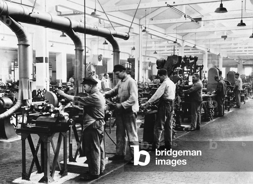 Industrial workers at their workplaces, 1934 (b/w photo)