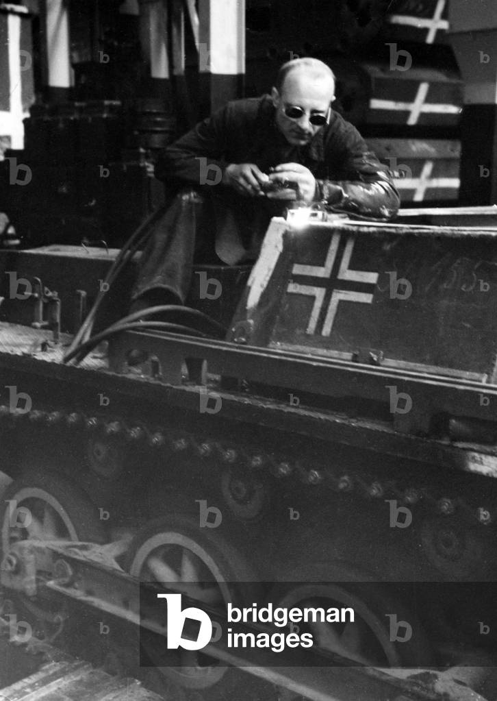 Welding work on a tracked vehicle, 1940 (b/w photo)