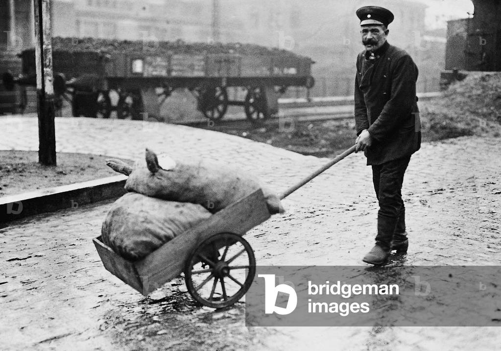 Railway official with purchased potato, 1922 (b/w photo)