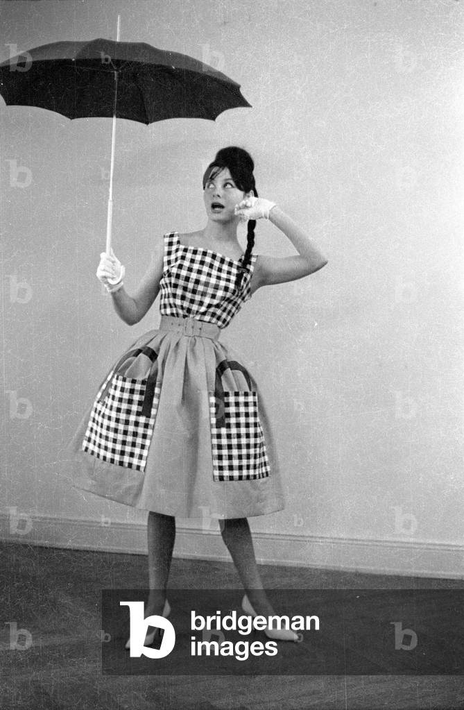 A model presents clothes from new collections, 1959 (b/w photo)