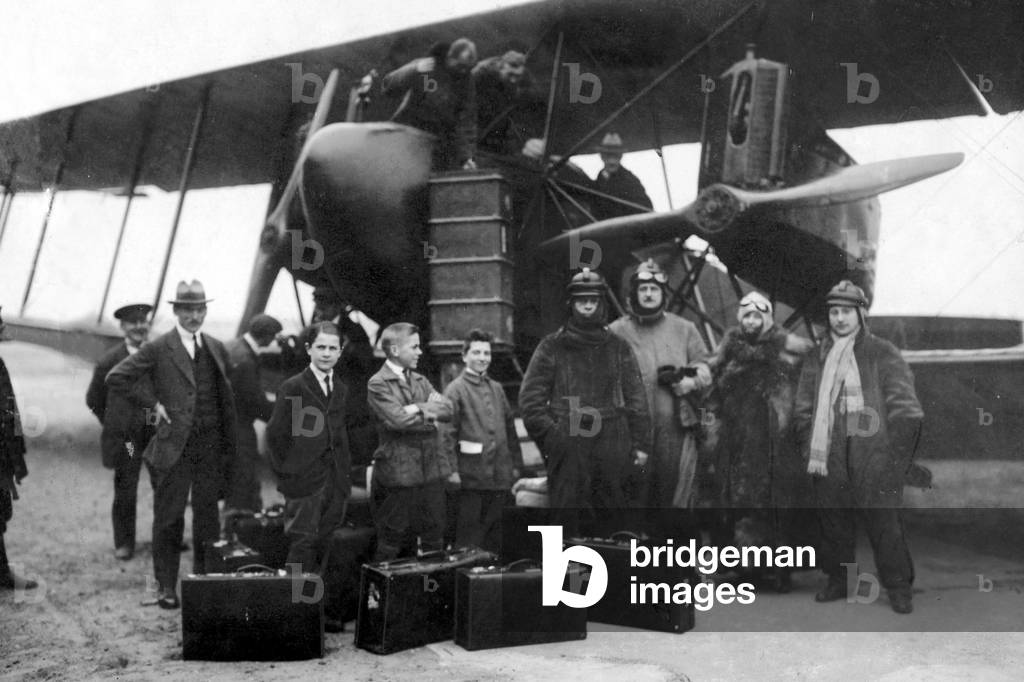 Passengers and luggage at an airplane, 1919 (b/w photo)