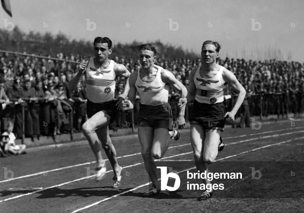 Mehlhose, Rudolf Harbig and Geise during a competition in Berlin, Germany, 1941 (b/w photo)