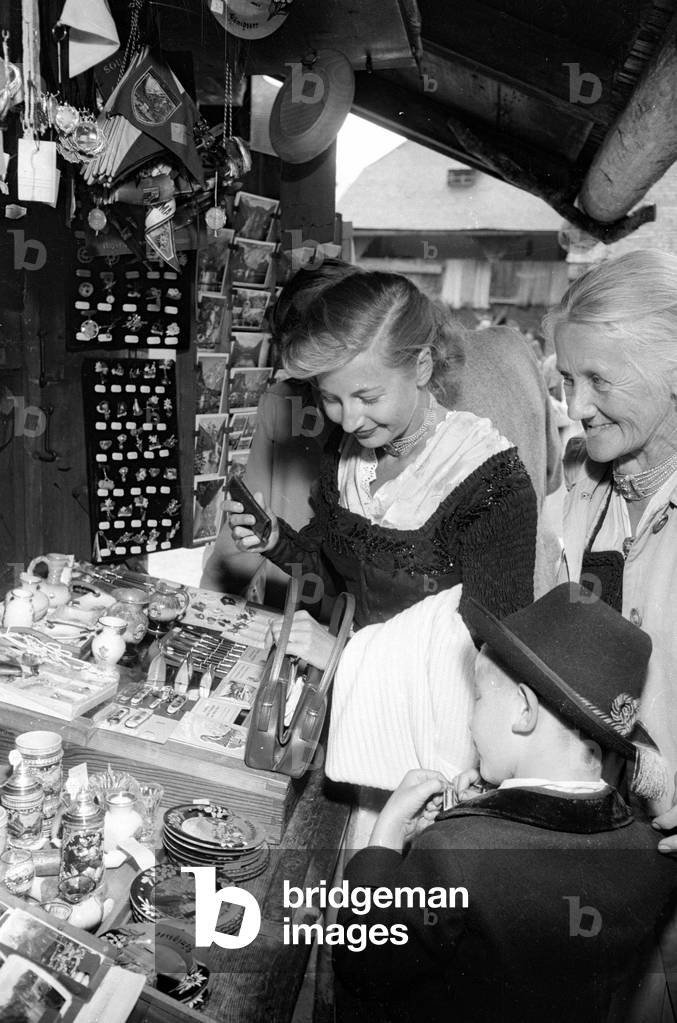 Pilgrims buy souvenirs, 1954 (b/w photo)