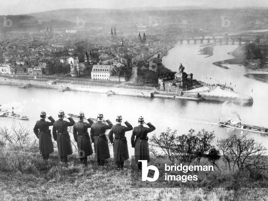 German policemen salute in the direction of the 