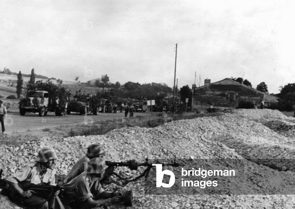 Wehrmacht soldiers secure a transport column in France, 1944 (b/w photo)