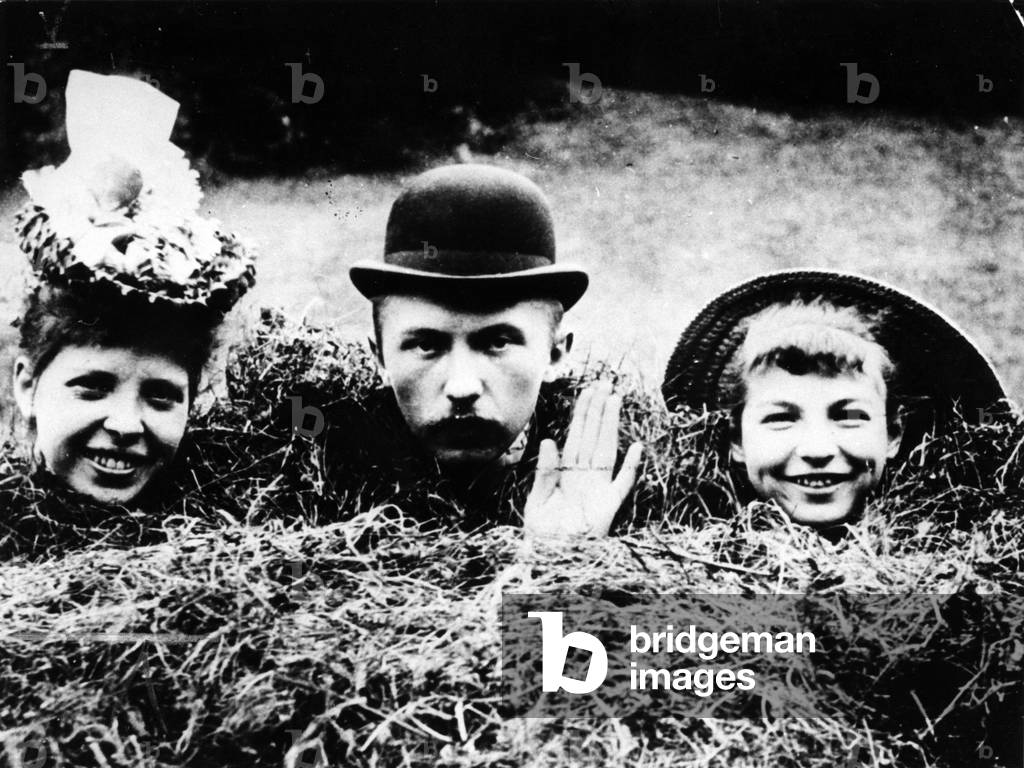 Konrad Adenauer (center) at the age of 22, with holiday acquaintances in a haystack, Aggertal, Germany, 1898 (b/w photo)