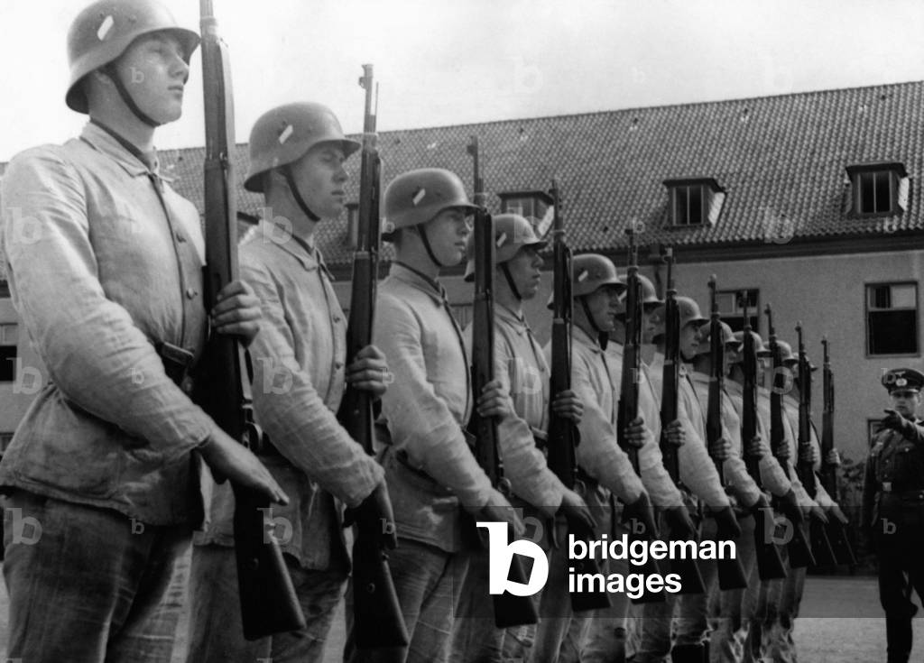 Recruits during rifle salute, 1940 (b/w photo)