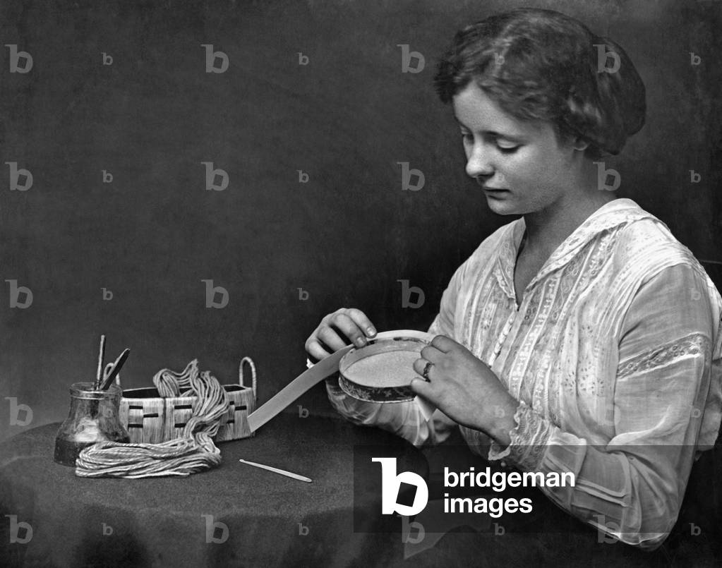 Woman doing handicraft, turn of the century (b/w photo)