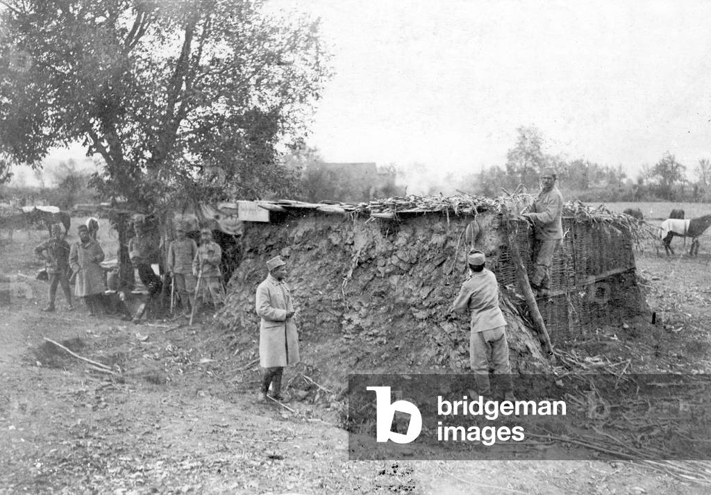 Austro-Hungarian soldiers building mud huts, 1915 (b/w photo)