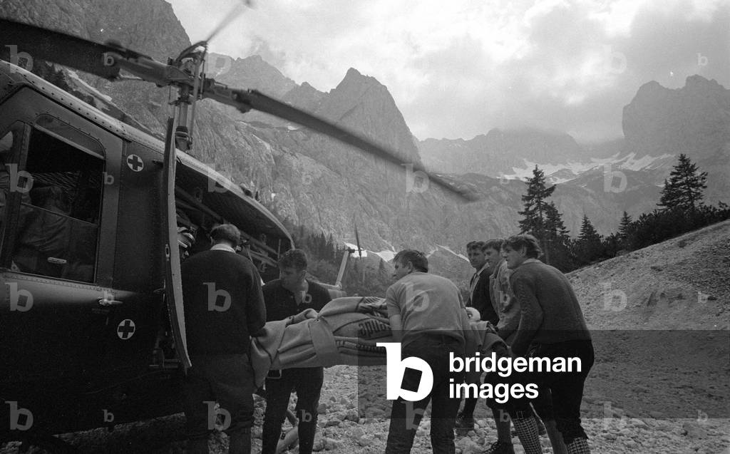 Rescue helicopter during a mission in the mountains, 1970 (b/w photo)