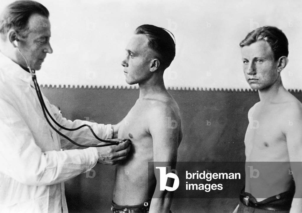 Doctor examines Ukrainian volunteers, 1942 (b/w photo)