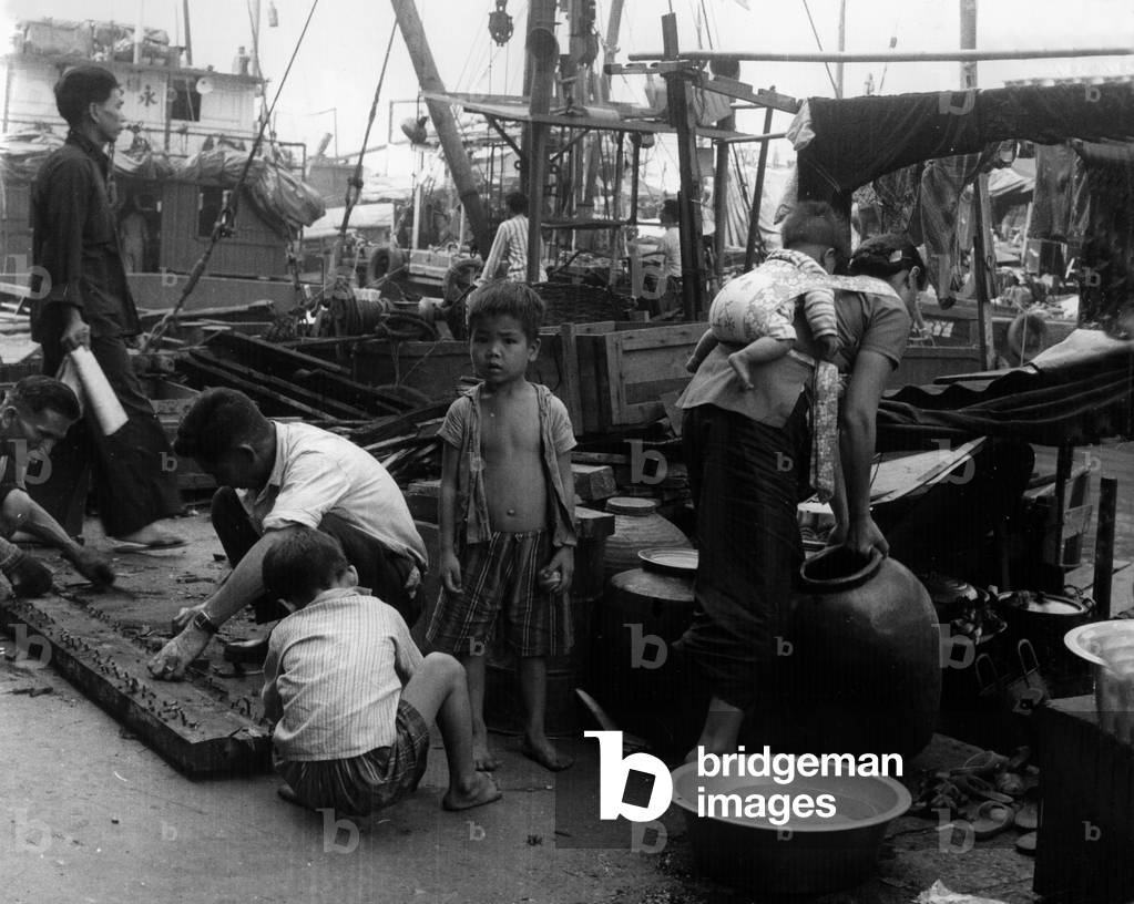 Family by the port in Hong Kong (b/w photo)