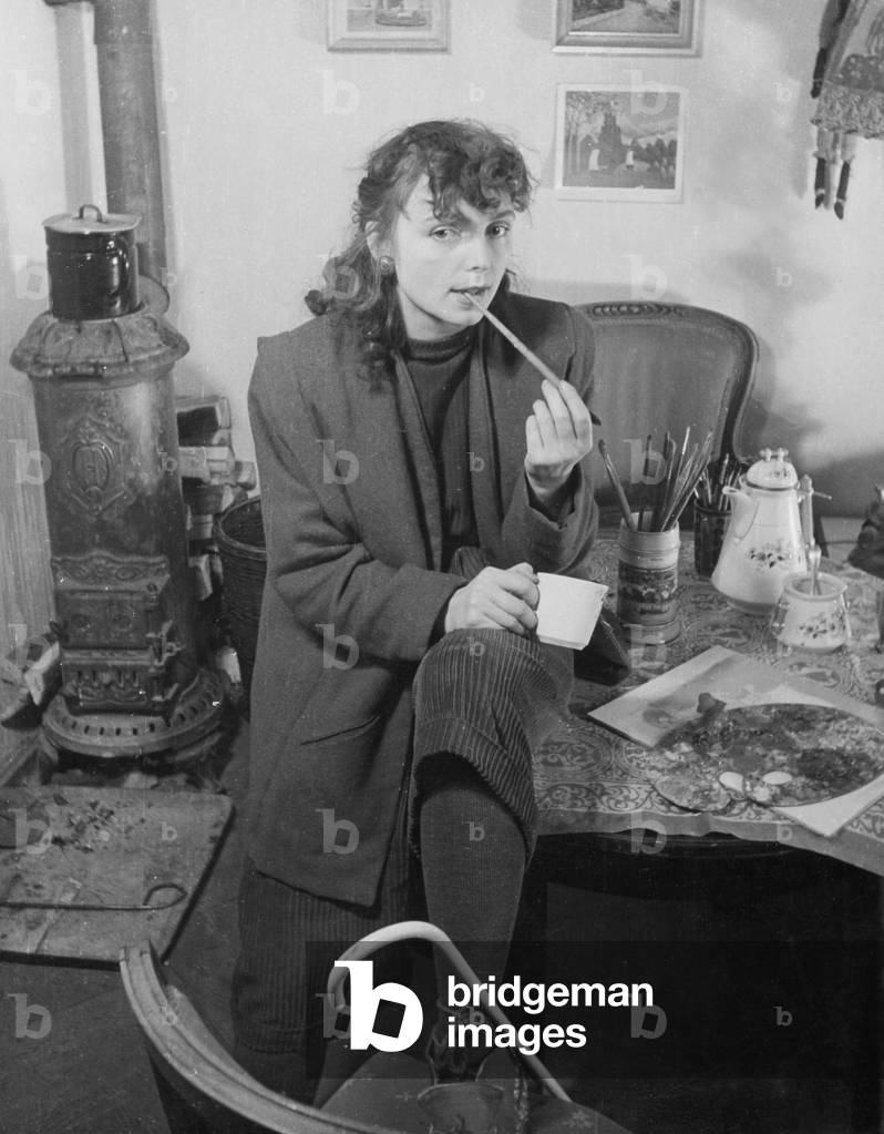 Painter in her poor apartment (b/w photo)