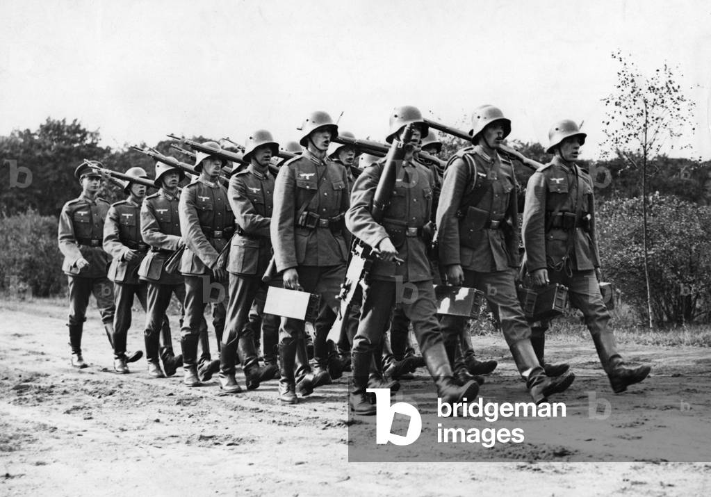 Recruits march with machine guns, 1935 (b/w photo)