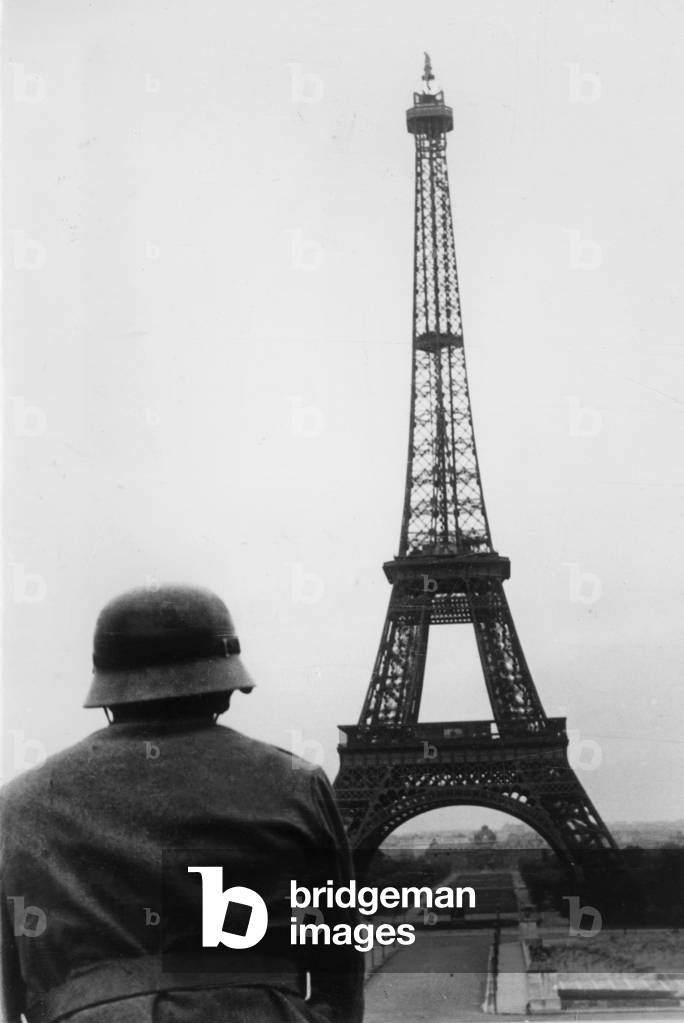 German Soldier in Front of the Eiffel Tower, 1940 (b/w photo)