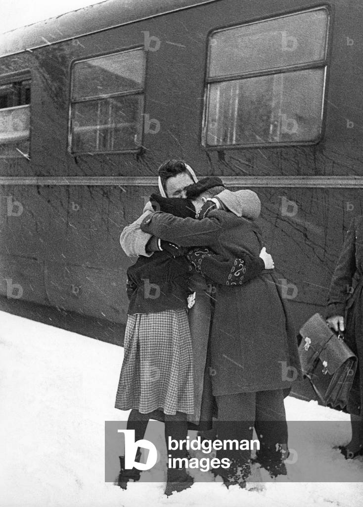 Homecomer from Czechoslovakia meets family (b/w photo)