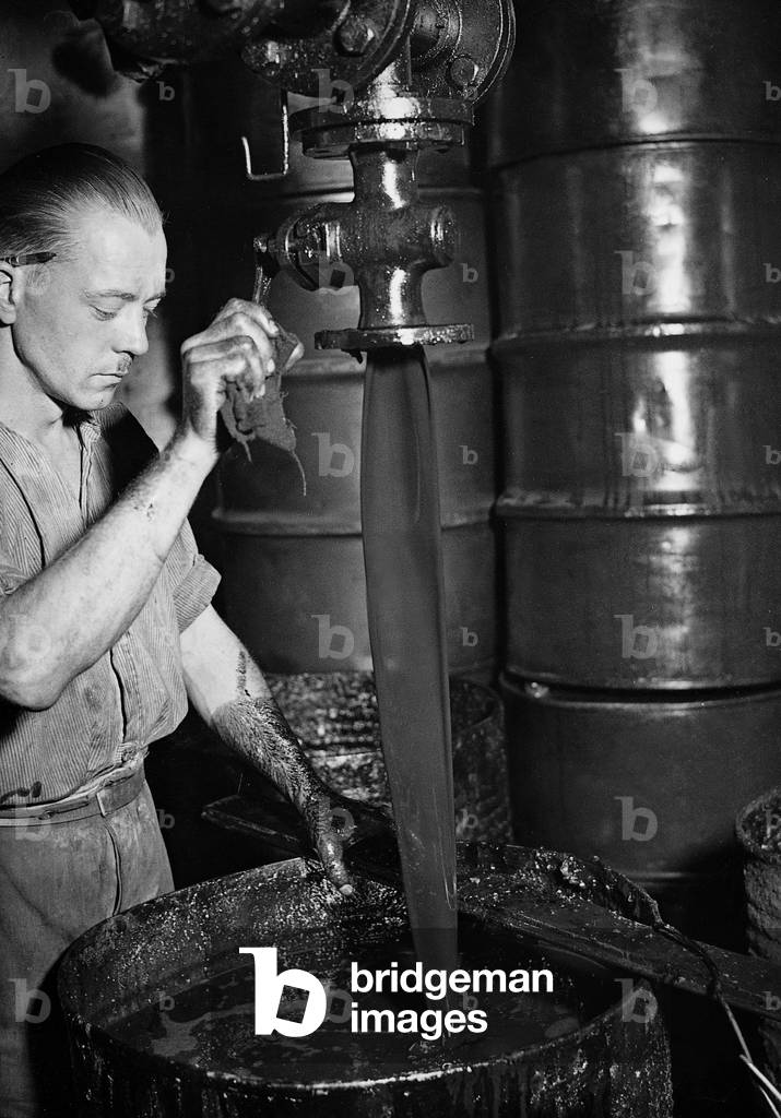 Letting out the residuals from the refinement process, 1936 (b/w photo)