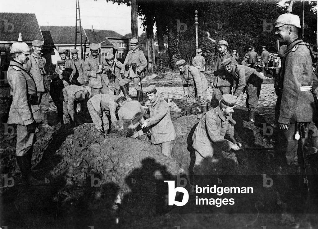 German soldiers dig for telephone cables, 1914 (b/w photo)