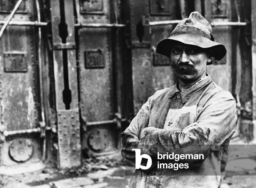 Industrial worker at the blast furnace, 1934 (b/w photo)