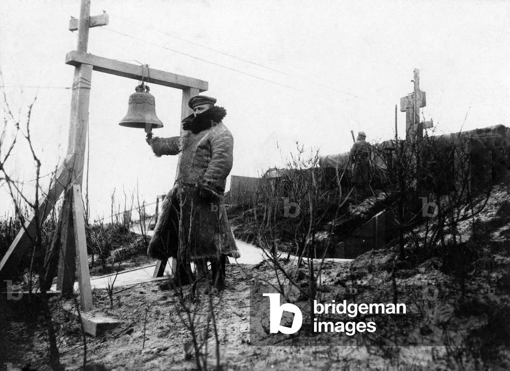 A German Marine by an alarm bell on the coast of Flanders, which calls in an emergency on the use of Air Defence, 1917 (b/w photo)