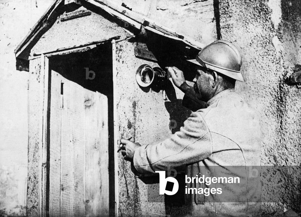 A French soldier gives gas alarm, 1916 (b/w photo)