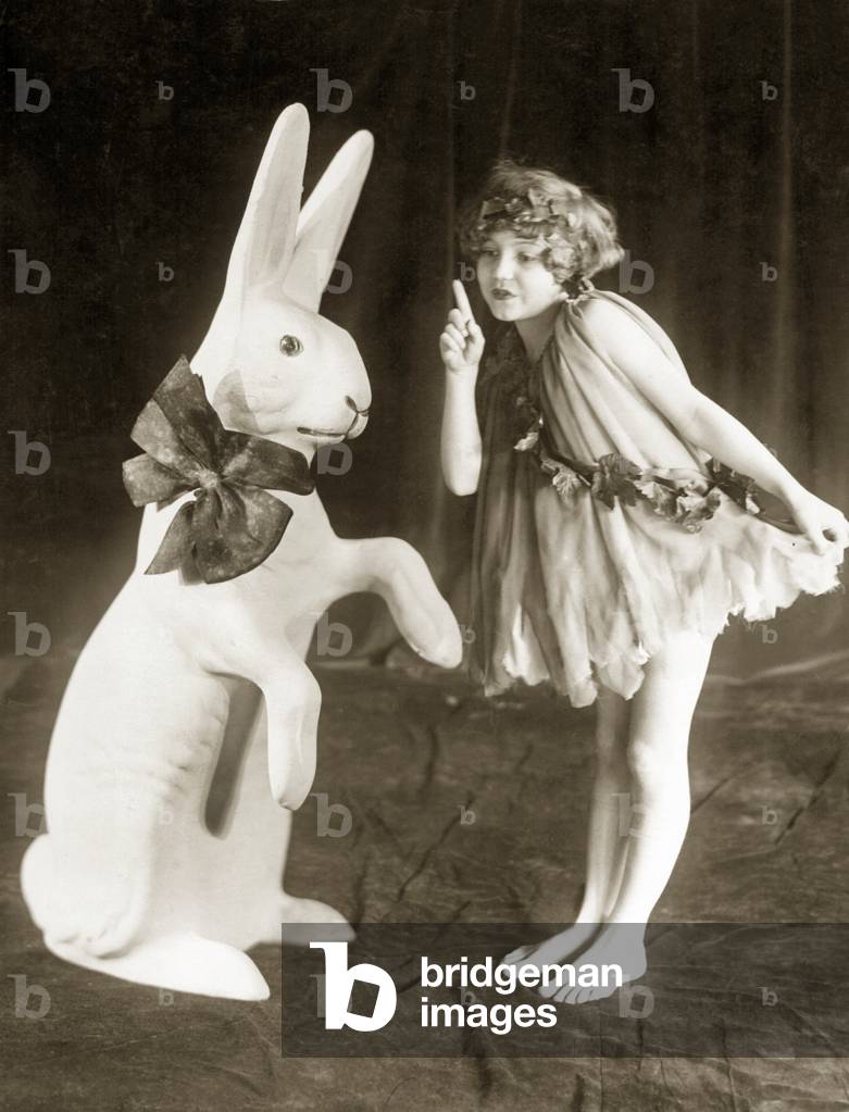 A girl and an Easter Bunny, 1925 (b/w photo)