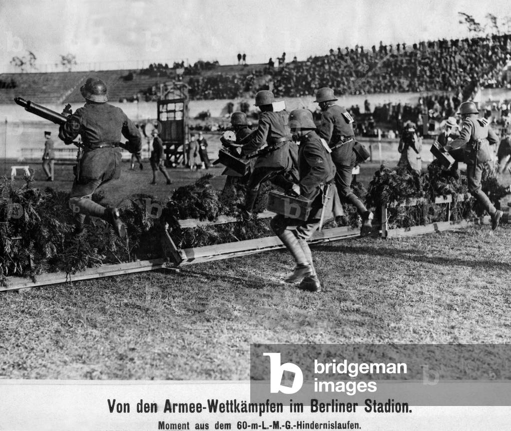Soldiers during an obstacle course with machine guns, 1919 (b/w photo)