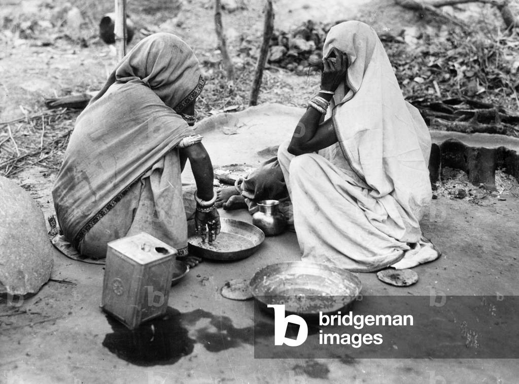 Two Indian women having a meal, 1930 (b/w photo)