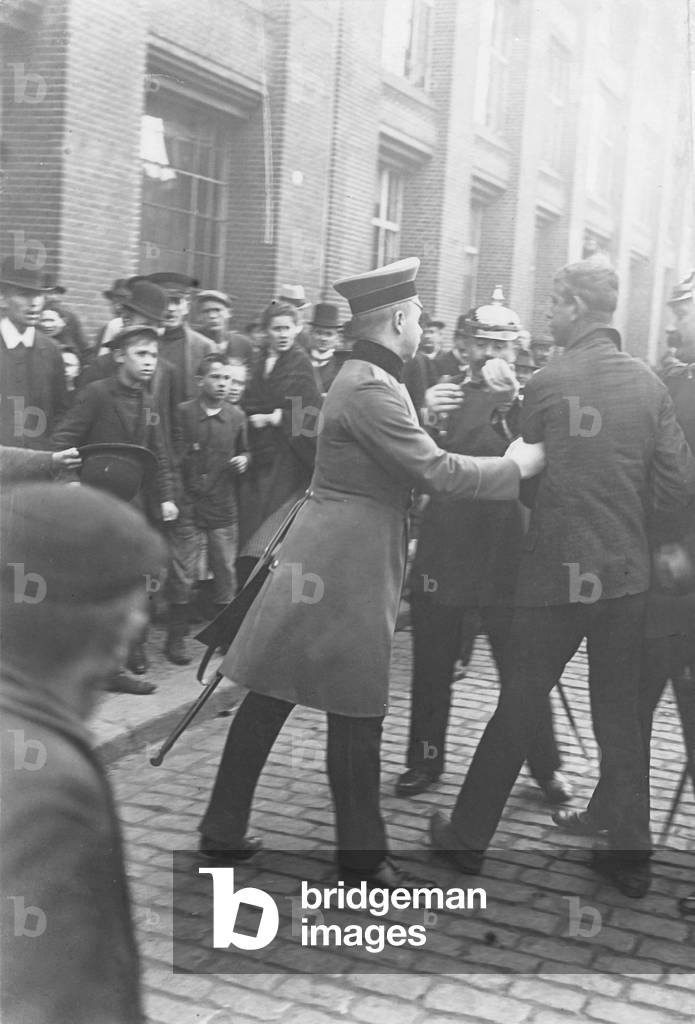 Police arrest a rioter during a strike. 1910 (b/w photo)