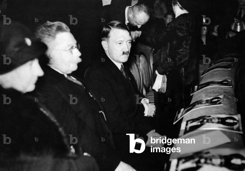 Alfred Hugenberg and Adolf Hitler at a movie premier, 1933