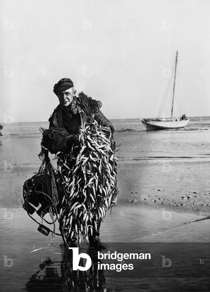 Fisherman with his catch (b/w photo)