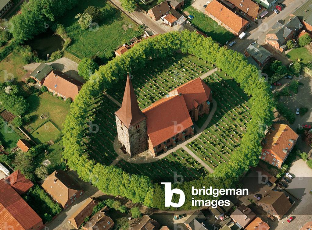 View of the Church and its cemetery are within a ring of trees, Petersdorf auf Fehmarn, Germany, 2008 (photo)