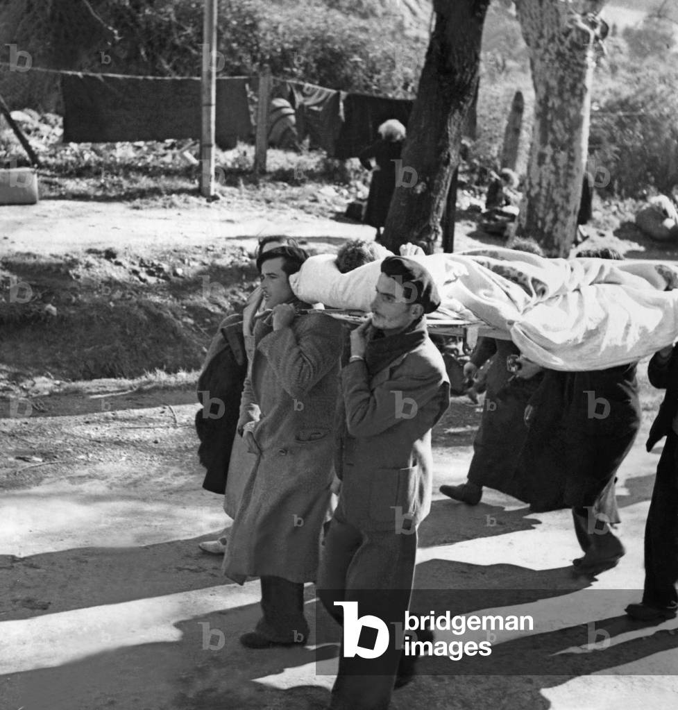 Republican fighters carry a wounded, 1939